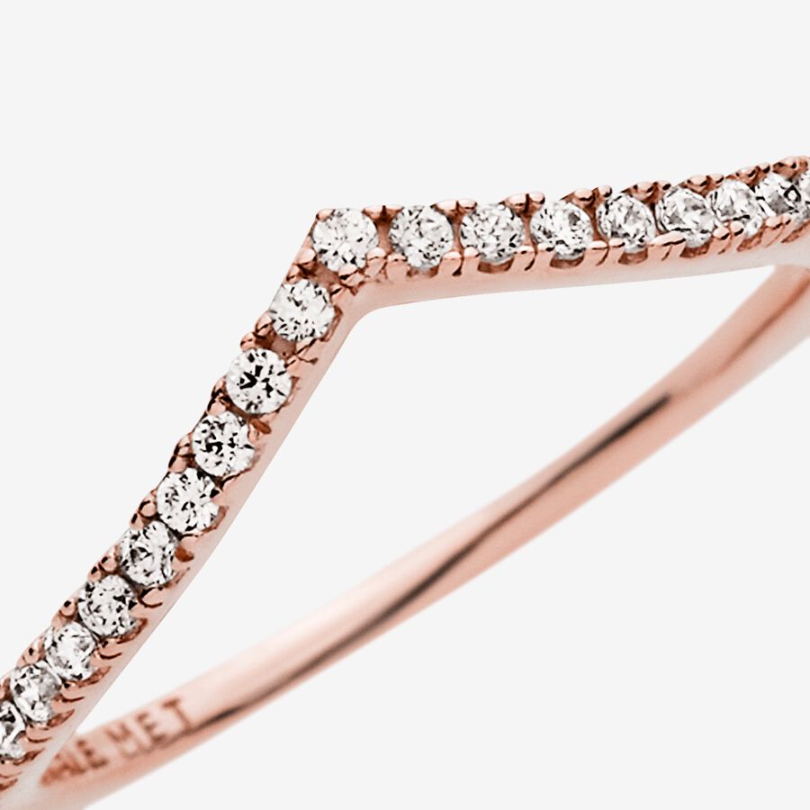 Sparkling Wishbone Ring - Pandora West Africa Rings Make all your wishes come true with this delicate Sparkling Wishbone Ring, lined with cubic zirconia stones on a 14k rose gold-plated band. Simple yet elegant, this wishbone-shaped ring can be worn on its own as a shimmering statement, or paired with other Pandora stackable rings to create a unique, highly individual look. (186316CZ-56)
