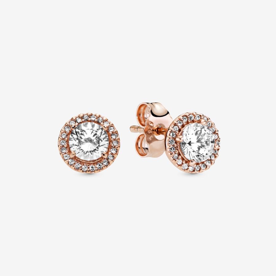 Round Sparkle Halo Stud Earrings - Pandora West Africa Earrings When you want classic elegance and a dose of drama, reach for these Round Sparkle Halo Stud Earrings. With a distinctly vintage feel, the 14k rose gold-plated, hand-finished pieces are centred with a brilliant cubic zirconia that is surrounded by a halo of smaller stones. The earrings work with everything, day or night. Try styling them with the corresponding pendant necklace, inspired by antique jewellery box treasures. (286272CZ)  