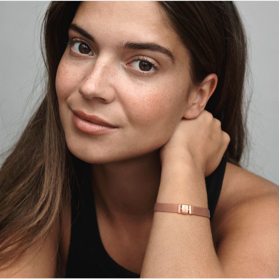 Pandora Reflexions™ Mesh Bracelet - Pandora West Africa Bracelets Pandora Reflexions is a modern way to reflect who you are. The Reflexions Mesh Bracelet holds clip-on charms that sit flush to mirror your style – whatever shape it takes. Plated with 14k rose gold for a blush-pink finish, this piece looks equally cool worn alone or stacked with other bracelets. Weave your story into your style and go gold and bold, adding your favourite charms from the collection. (587712-20)  