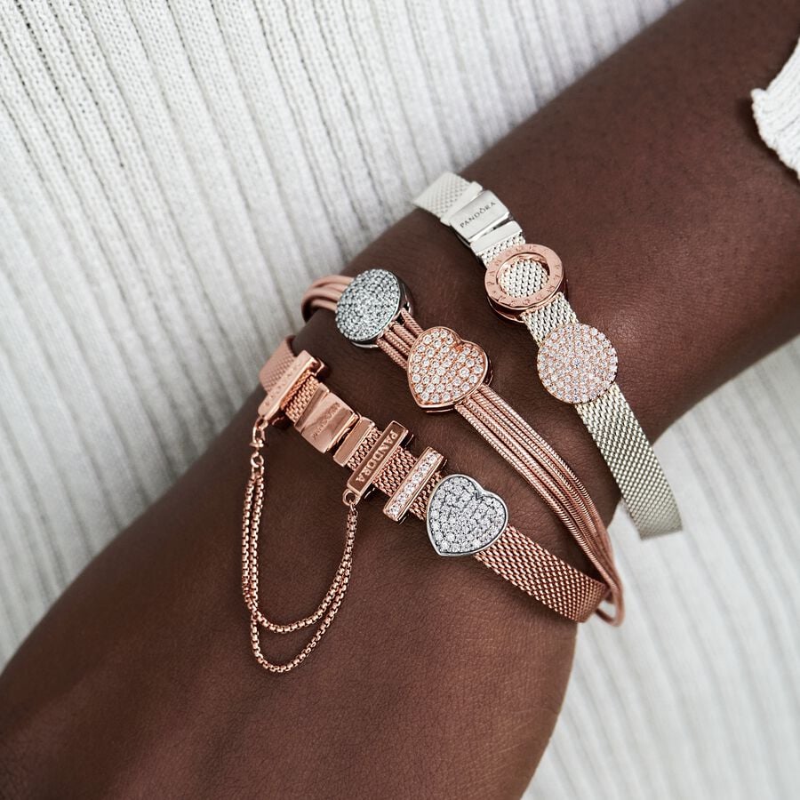 Pandora Reflexions™ Mesh Bracelet - Pandora West Africa Bracelets Pandora Reflexions is a modern way to reflect who you are. The Reflexions Mesh Bracelet holds clip-on charms that sit flush to mirror your style – whatever shape it takes. Plated with 14k rose gold for a blush-pink finish, this piece looks equally cool worn alone or stacked with other bracelets. Weave your story into your style and go gold and bold, adding your favourite charms from the collection. (587712-20)  