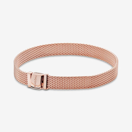 Pandora Reflexions™ Mesh Bracelet - Pandora West Africa Bracelets Pandora Reflexions is a modern way to reflect who you are. The Reflexions Mesh Bracelet holds clip-on charms that sit flush to mirror your style – whatever shape it takes. Plated with 14k rose gold for a blush-pink finish, this piece looks equally cool worn alone or stacked with other bracelets. Weave your story into your style and go gold and bold, adding your favourite charms from the collection. (587712-20)  