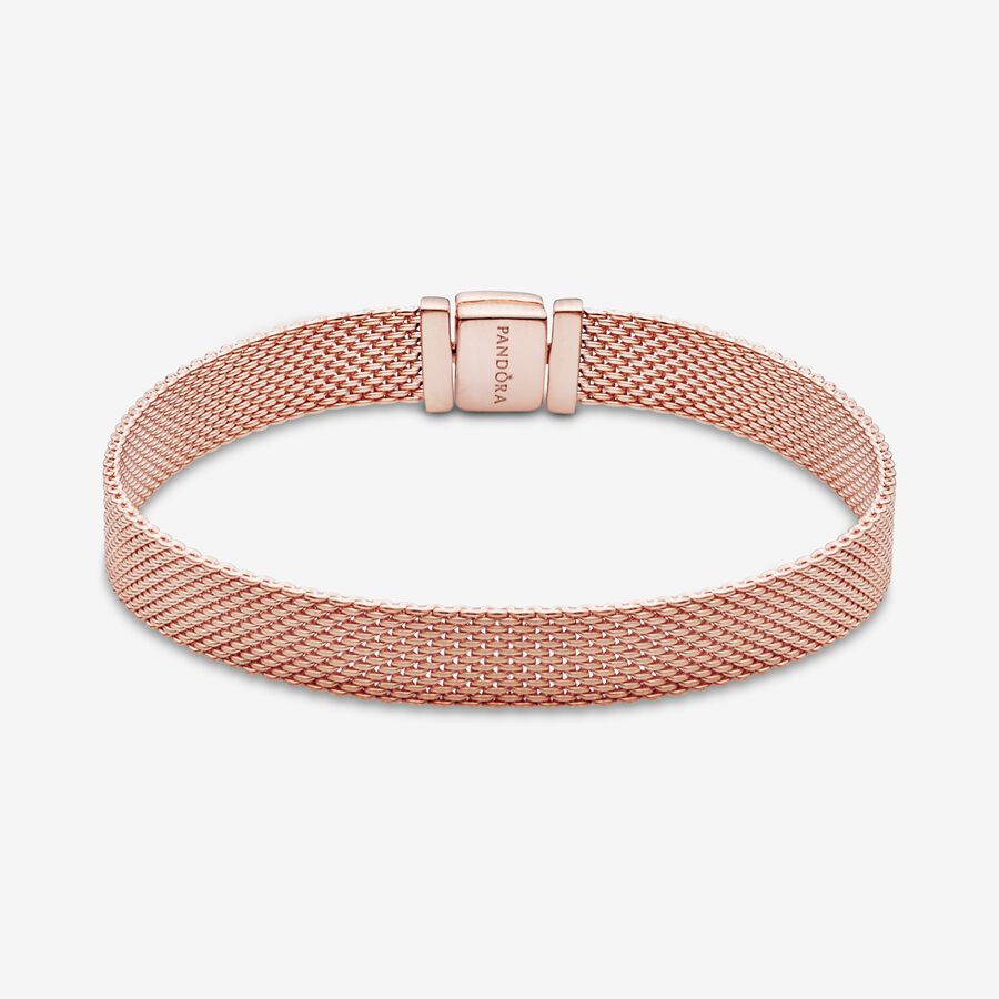 Pandora Reflexions™ Mesh Bracelet - Pandora West Africa Bracelets Pandora Reflexions is a modern way to reflect who you are. The Reflexions Mesh Bracelet holds clip-on charms that sit flush to mirror your style – whatever shape it takes. Plated with 14k rose gold for a blush-pink finish, this piece looks equally cool worn alone or stacked with other bracelets. Weave your story into your style and go gold and bold, adding your favourite charms from the collection. (587712-20)  