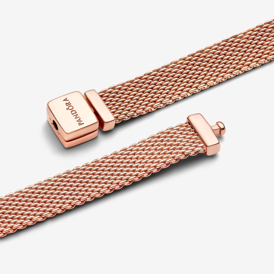 Pandora Reflexions™ Mesh Bracelet - Pandora West Africa Bracelets Pandora Reflexions is a modern way to reflect who you are. The Reflexions Mesh Bracelet holds clip-on charms that sit flush to mirror your style – whatever shape it takes. Plated with 14k rose gold for a blush-pink finish, this piece looks equally cool worn alone or stacked with other bracelets. Weave your story into your style and go gold and bold, adding your favourite charms from the collection. (587712-20)  