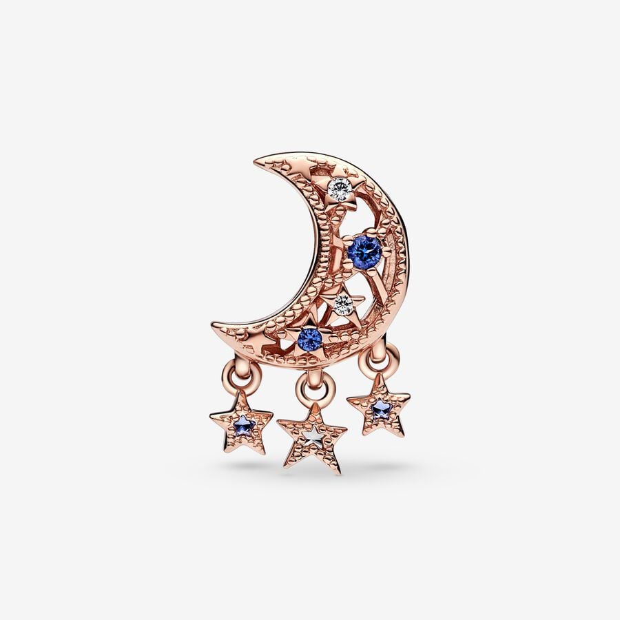 Star & Crescent Moon Charm - Pandora West Africa Charms Add celestial sparkle to any look with the Star & Crescent Moon Charm. Finished in 14k rose gold plating, the charm has been carefully detailed by hand with rows of cubic zirconia and cut-out star and circle shapes. Microbeads decorate the edges and asymmetric stars with stones and microbeads dangle from the sides. The cosmic charm is engraved with the message "Dream big" to remind you to always reach for the stars. (789643C01)  